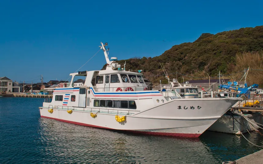 The fishing harbour of Kishi in Itoshima, where eleven oyster huts open in winter; the boat is the ferry to Himeshima