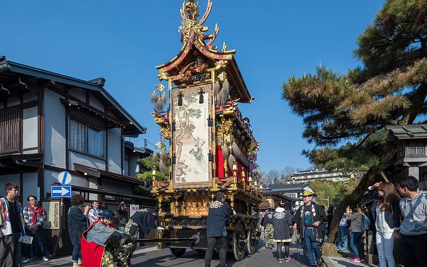 A festival float moving through the old town of Takayama